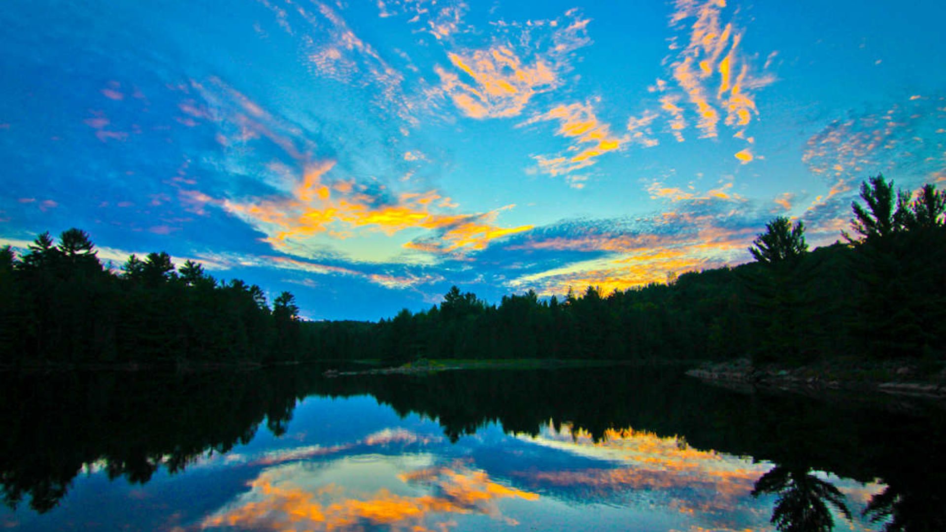 Colourful reflection of a sunset in the waters of the Ottawa River