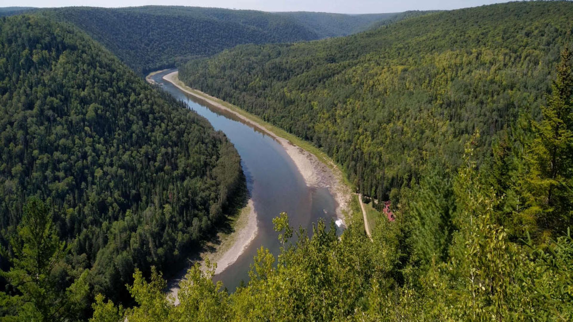 View of the Restigouche River and a beautiful Acadian forest at the Horizon de Rêve lookout in Saint-Alexis de Matapédia.