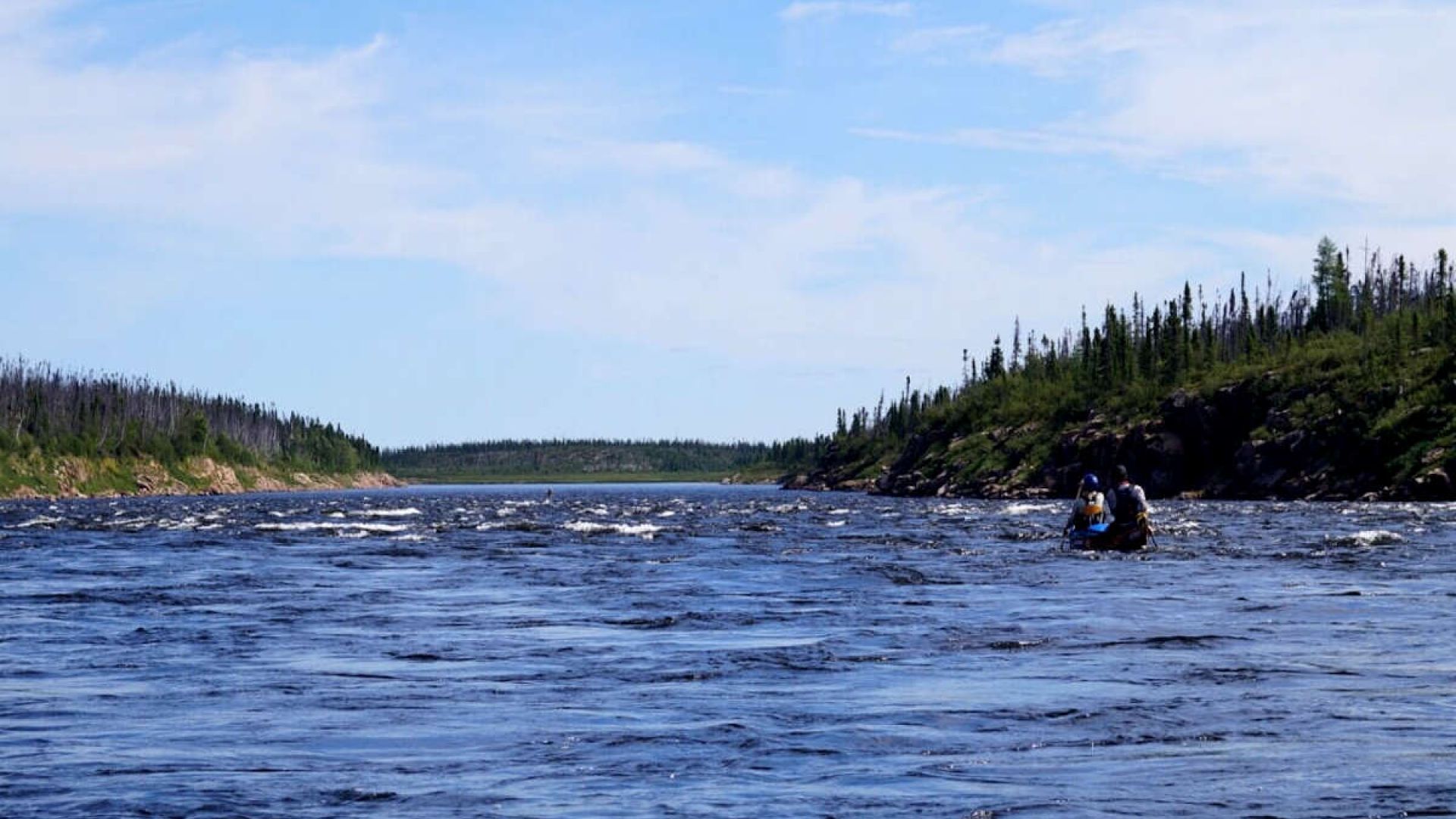 Canoes paddling through light rapids on the Seal River. (Photo: Know the North)