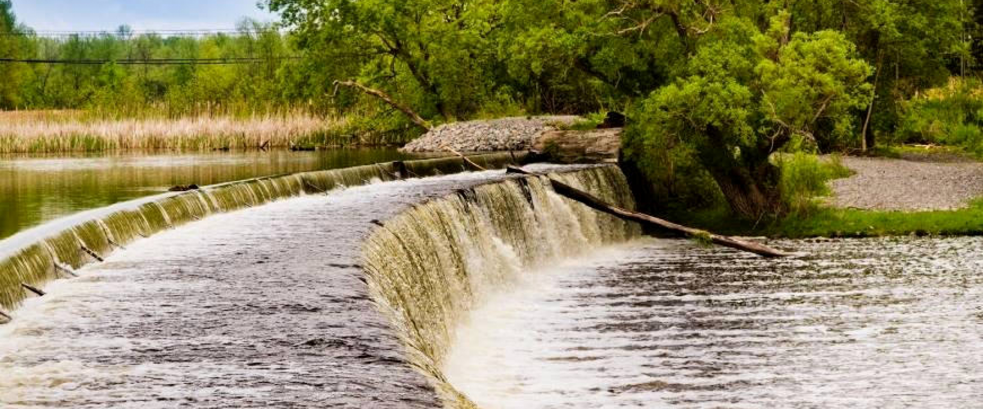 Water flowing over the stone arch dam at Edmonds Lock.